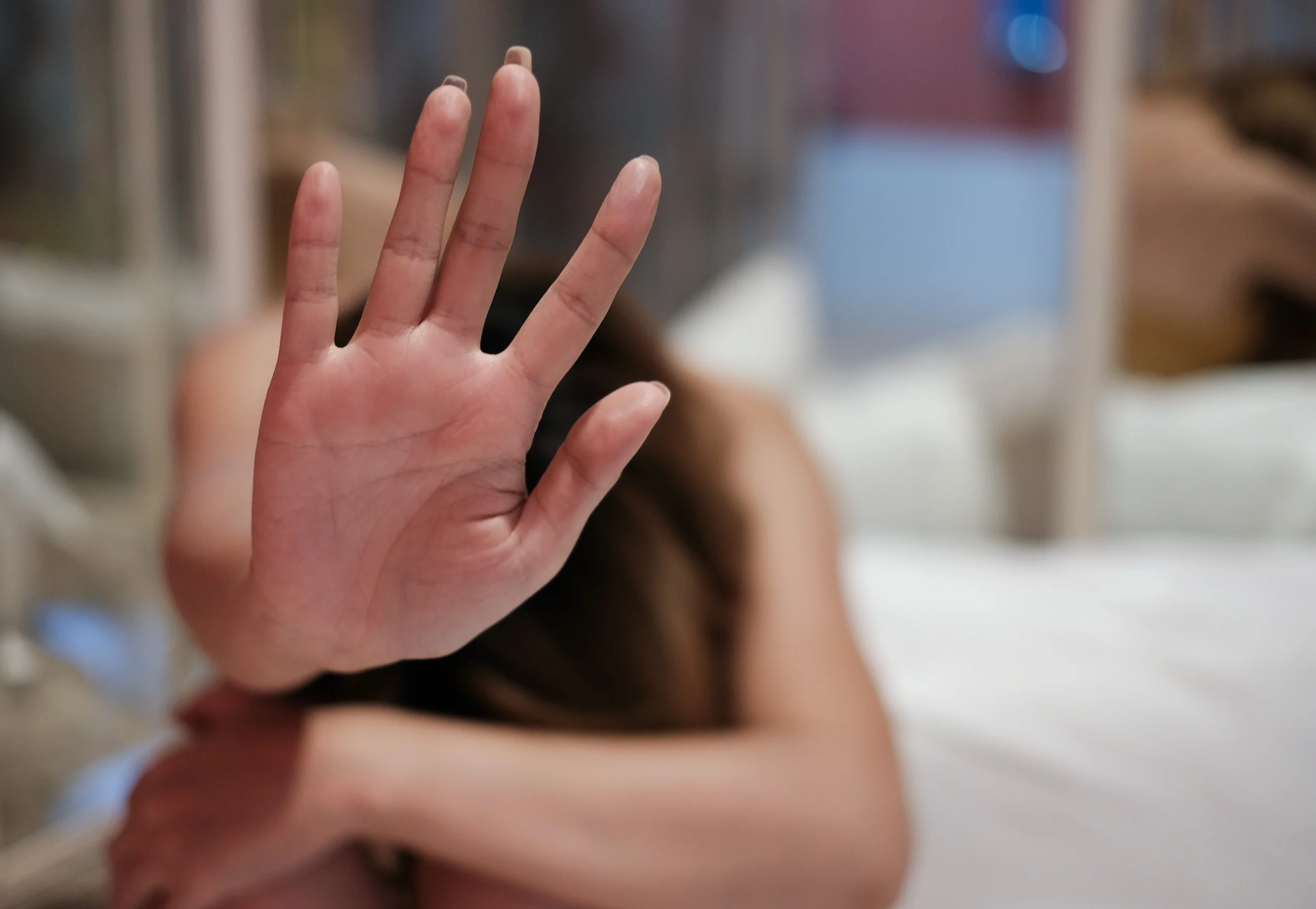 woman holding her hand up in defense